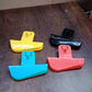 Plastic Secure Mobile Phone Charging Stand Holder (1 Pc / Mix Color)